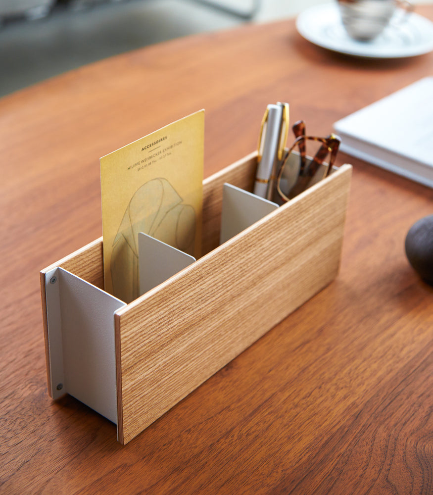 View 4 - Close up view of ash Organizer Caddy containing pen and glasses on table by Yamazaki Home.