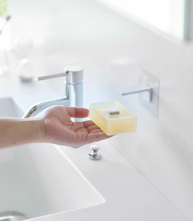 Taking out soap from white Yamazaki Home Magnetic Soap Holder view 3