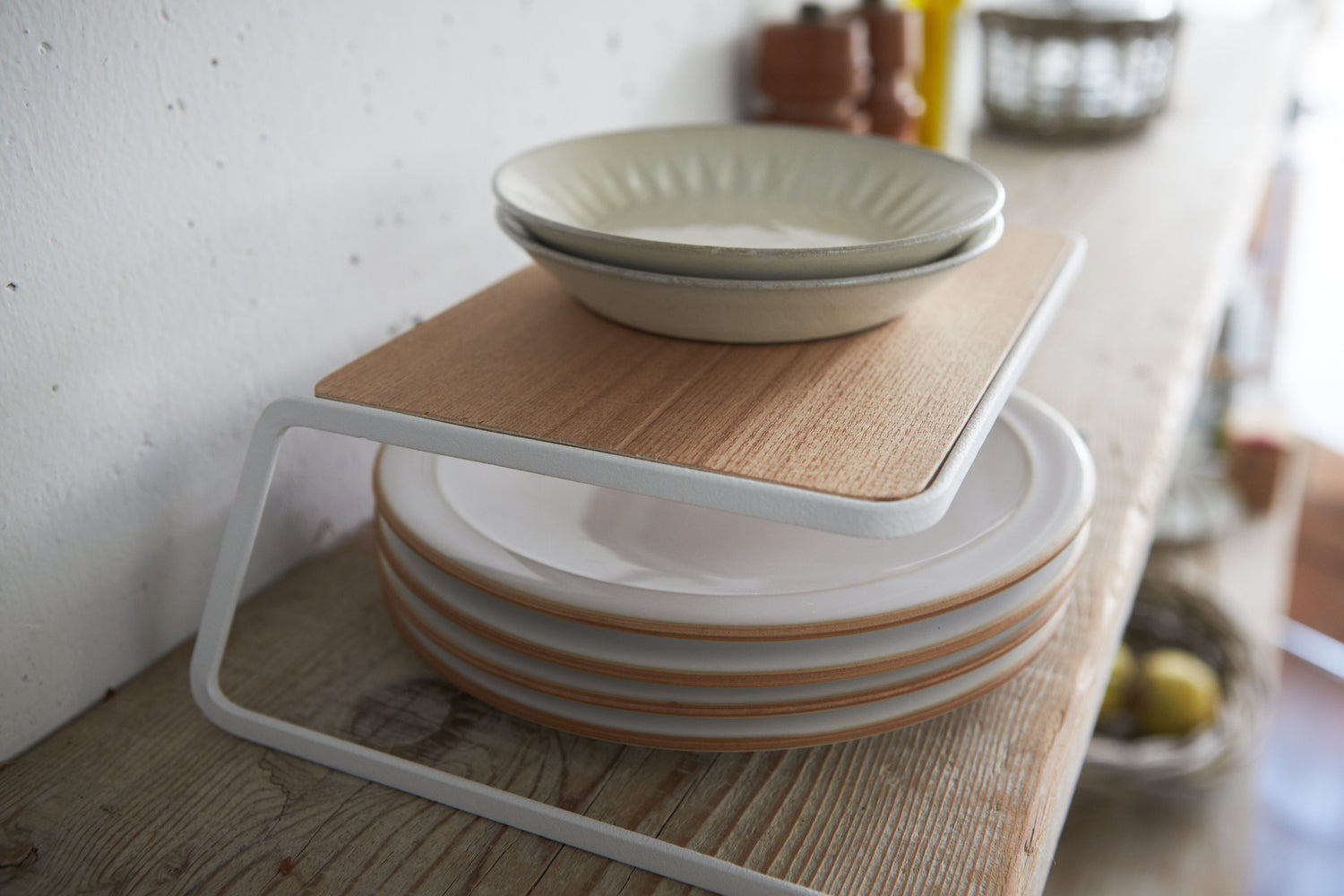 View 4 - Side view of Dish Riser displaying plates on shelf by Yamazaki Home.