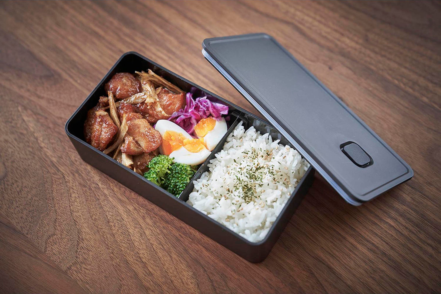 View 23 - Black Vacuum-Sealing Bento Box holding lunch food by Yamazaki Home.