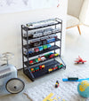 Black Kids' Parking Garage holding toy trains and cars by Yamazaki Home.