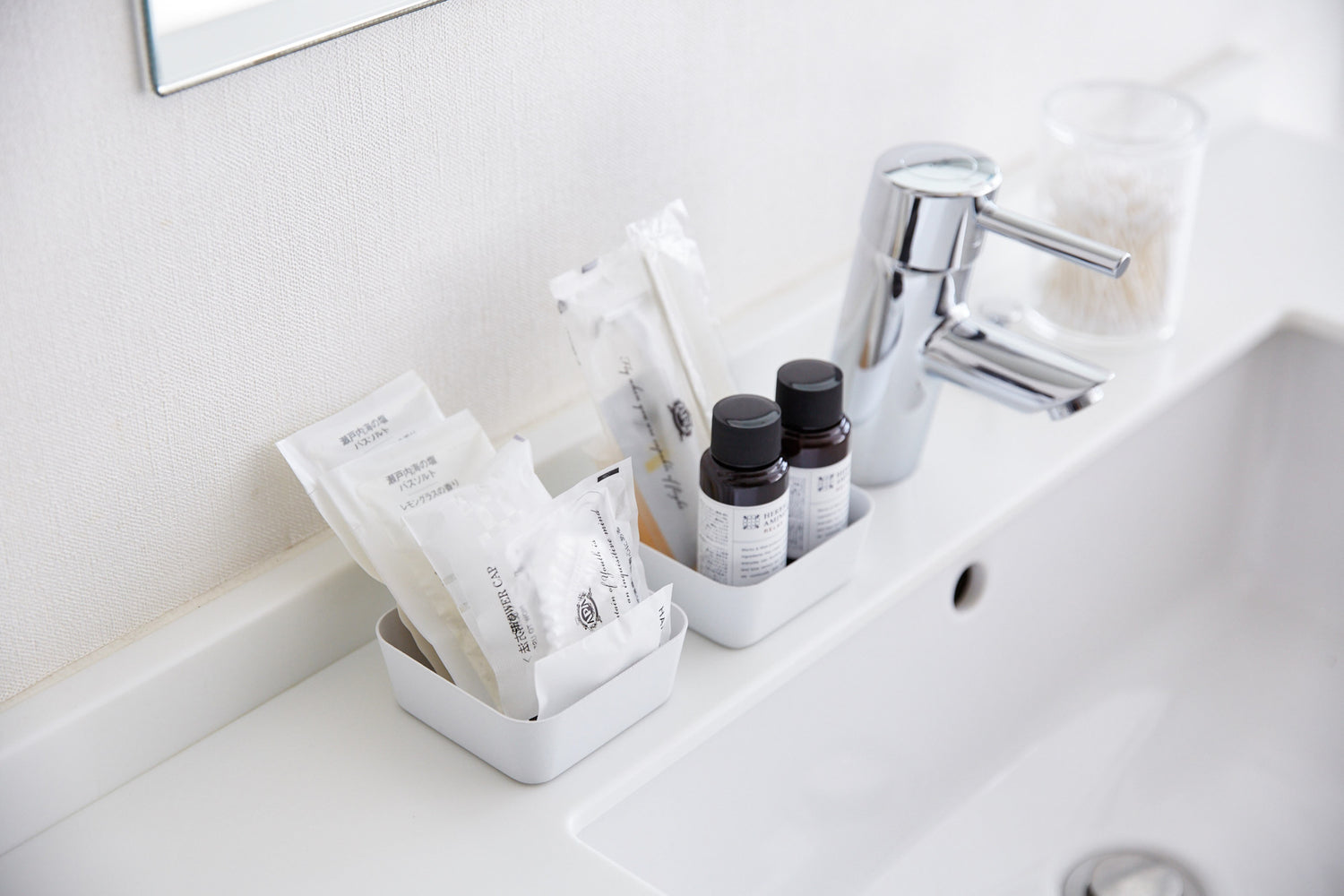 View 3 - Small white Accessory Trays holding beauty items on bathroom sink counter by Yamazaki Home.