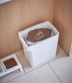 Aerial view of white Airtight Food Storage Container holding pet food next to white Pet Food Bowl by Yamazaki Home. view 32