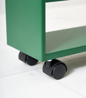 Close up of wheels on Forest Green Yamazaki Home Slim Storage Cart view 9