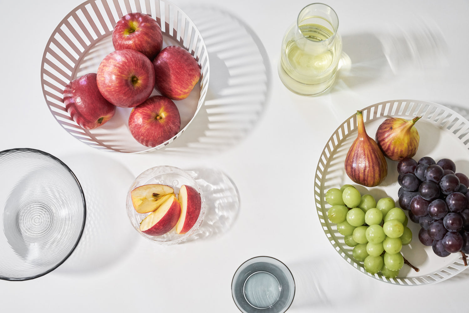 View 7 - Aerial view of white Fruit Basket displaying fruit on white tabletop by Yamazaki Home.