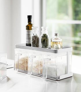 White Pantry Organizer with upper shelf holding spices and oils by Yamazaki Home. view 2