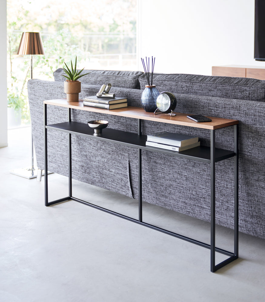 View 26 - Black Yamazaki Home Long Console Table - Shelf  with books and decorations on it