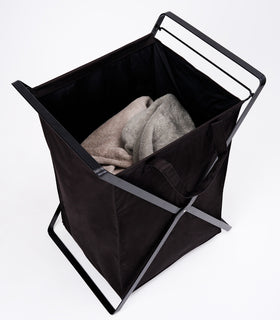 Large Laundry Hamper with Cotton Liner in black by Yamazaki Home on a white background with towels inside. view 27