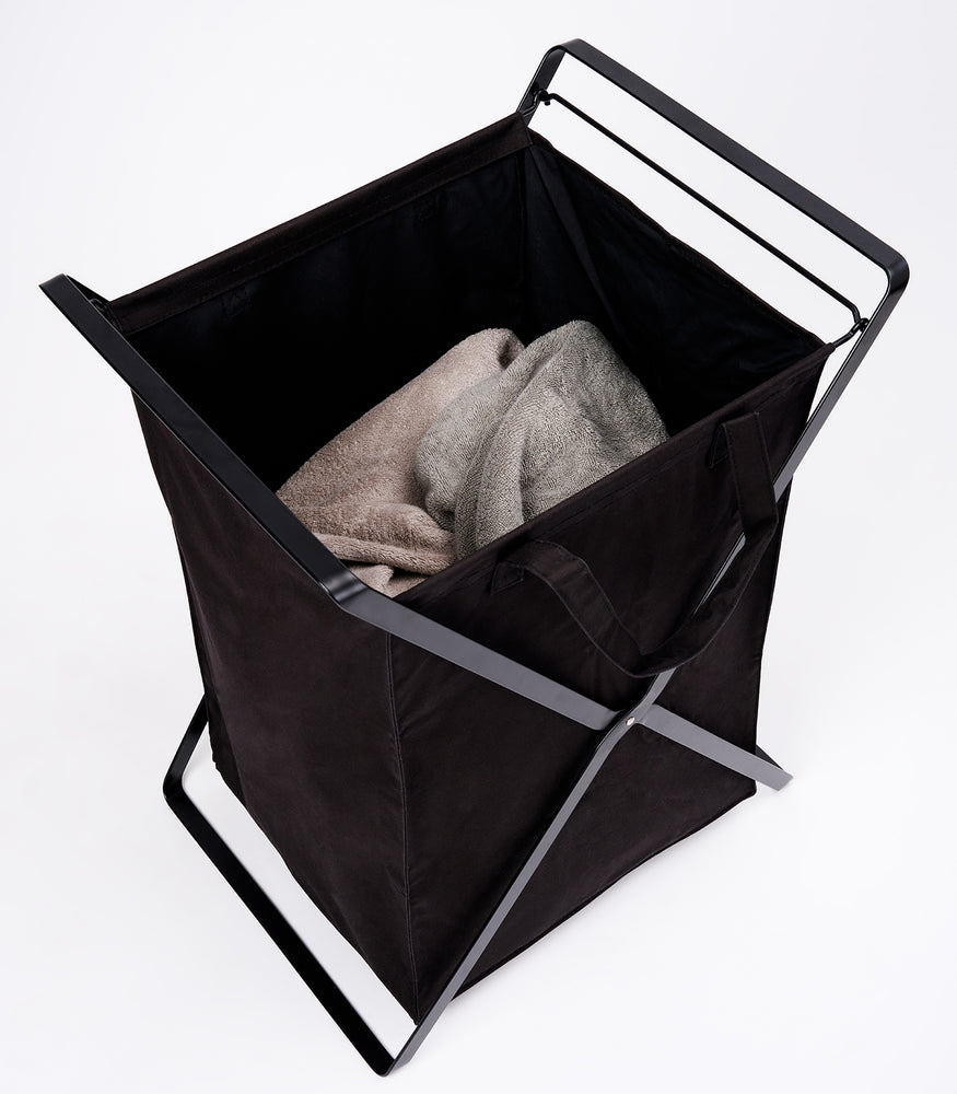 View 27 - Large Laundry Hamper with Cotton Liner in black by Yamazaki Home on a white background with towels inside.