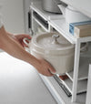 Somone is taking out a pot from Three-Tier Cabinet Storage Rack.