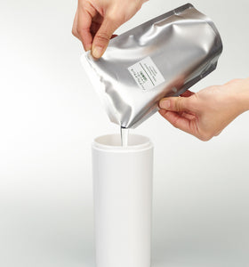 Front view of white Shampoo Dispenser getting filled with shampoo on white background by Yamazaki Home. view 6