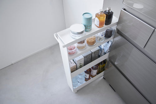 Top-down view of White Yamazaki Home Slim Rolling Cart holding coffee and drinks