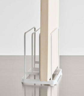 Close up of white Yamazaki Round Cutting Board Stand with a rectangular cutting board view 8