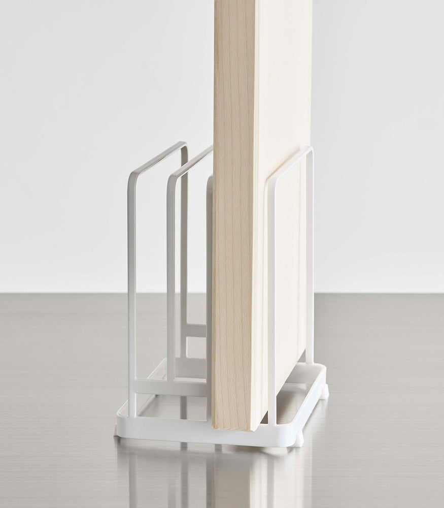 View 8 - Close up of white Yamazaki Round Cutting Board Stand with a rectangular cutting board
