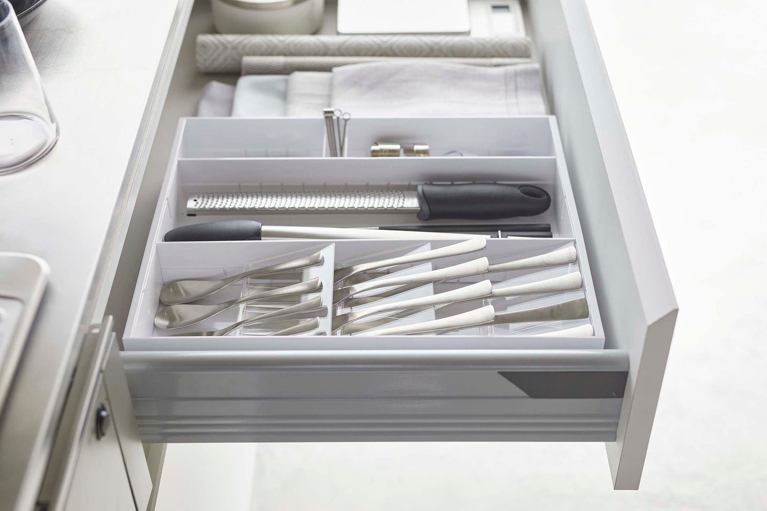 View 16 - Side view of white Expandable Cutlery Storage Organizer by Yamazaki Home.