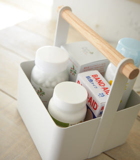 Close up aerial view of white Storage Caddy holding first aid items by Yamazaki Home. view 12