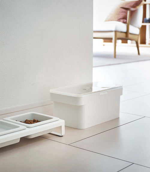 White Small Airtight Food Storage Container closed and next to white Pet Food Bowl by Yamazaki Home.