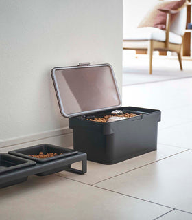 Black Airtight Food Storage Container open and next to black Pet Food Bowl by Yamazaki Home. view 12