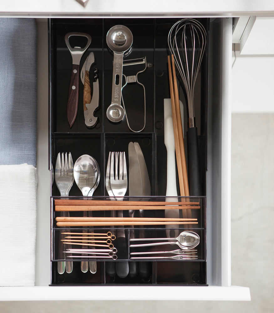 View 35 - Aerial view of black Expandable Drawer Organizer holding utensils by Yamazaki Home.
