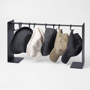 Yamazaki Home Hat Hanging Organizer with props, set against a white background.