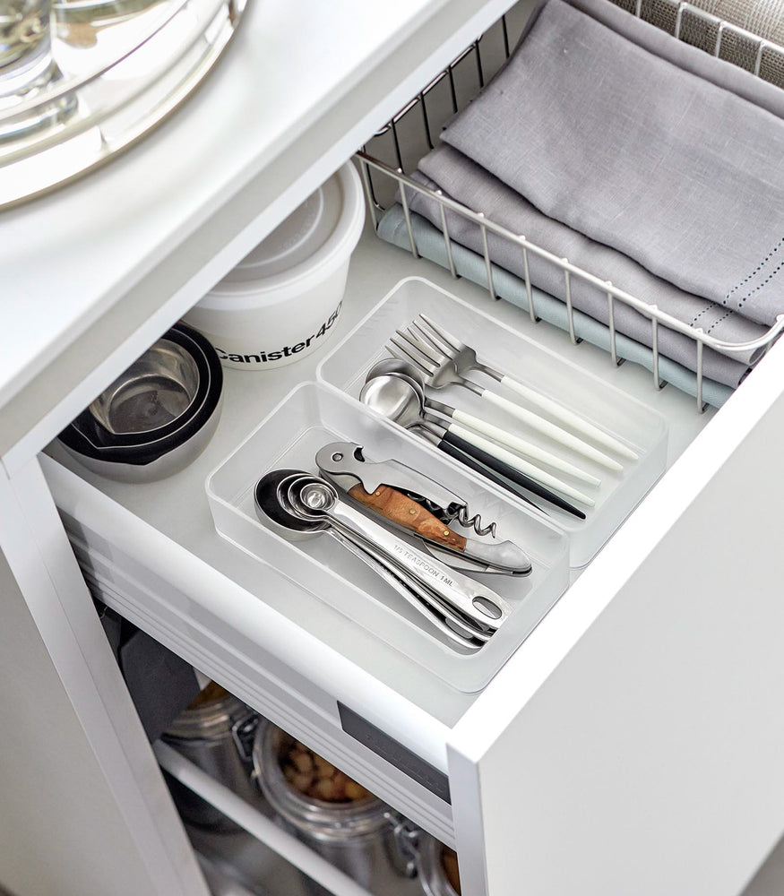 View 16 - Two medium stackable clear organizers are placed in a kitchen drawer, organizing cutlery and wine openers, neatly placed next to each other