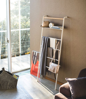 White Leaning Ladder Rack holding clothing items, accessories, and décor pieces in bedroom by Yamazaki Home. view 15