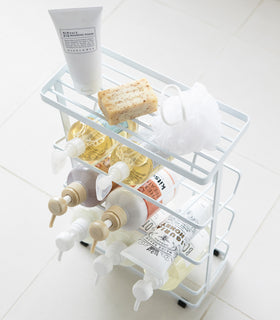 Aerial view of white Freestanding Shower Caddy holding beauty products in bathroom by Yamazaki Home. view 9
