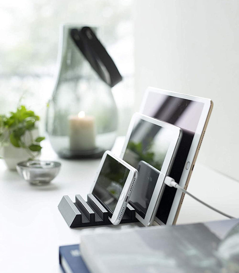Side view of black Phone and Tablet Stand holding phone and tablet by Yamazaki Home.