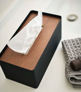 Aerial view of Yamazaki Home black Tissue Case holding tissues on bathroom countertop.  view 12