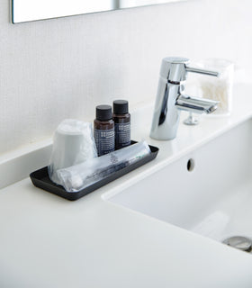 Flat black Accessory Tray holding toothbrush, cup, and soap on bathroom sink counter. view 19