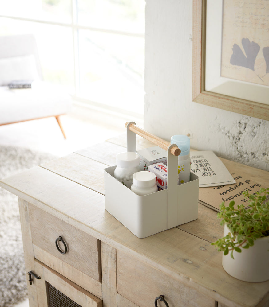 View 10 - White Storage Caddy holding first-aid items on bureau countertop by Yamazaki Home.