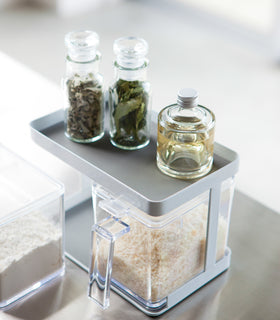 Aerial view of white Pantry Organizer holding rice and spices on upper shelf by Yamazaki Home. view 2