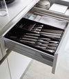 Two black Cutlery Storage Organizers holding silverware in kitchen drawer by Yamazaki Home.