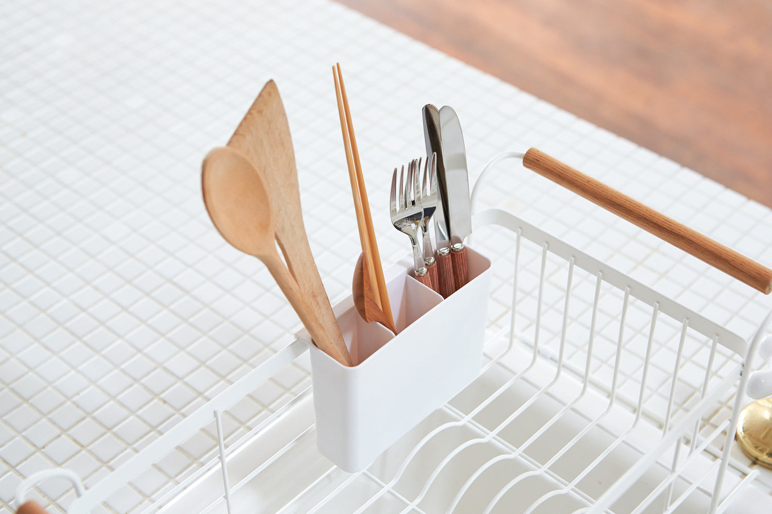 View 4 - White Over-the-Sink Expandable Dish Drying Rack holding silverware by Yamazaki Home.