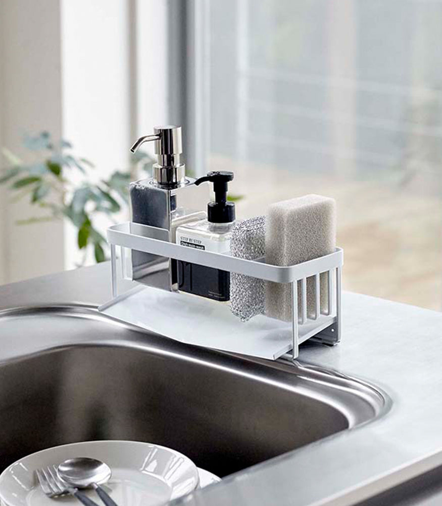 View 5 - White steel sponge and soap bottle holder with white draining tray.