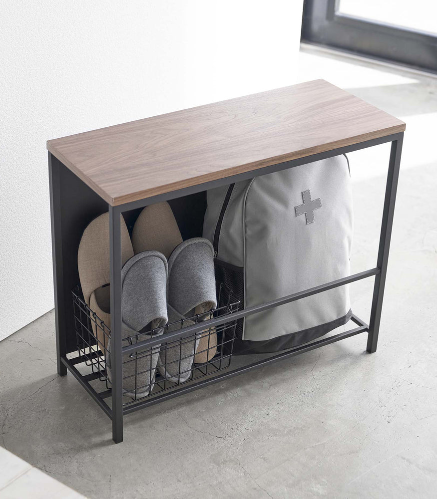View 11 - Black Yamazaki Discreet Entryway Storage Shelf filled with slippers and a backpack