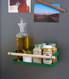 Forest Green Yamazaki Home Magnetic Storage Caddy with oil, herbs and spices stored attached to a refridgerator