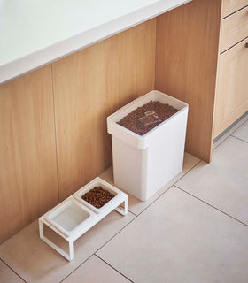 Aerial view of white Airtight Food Storage Container holding pet food next to white Pet Food Bowl by Yamazaki Home. view 30