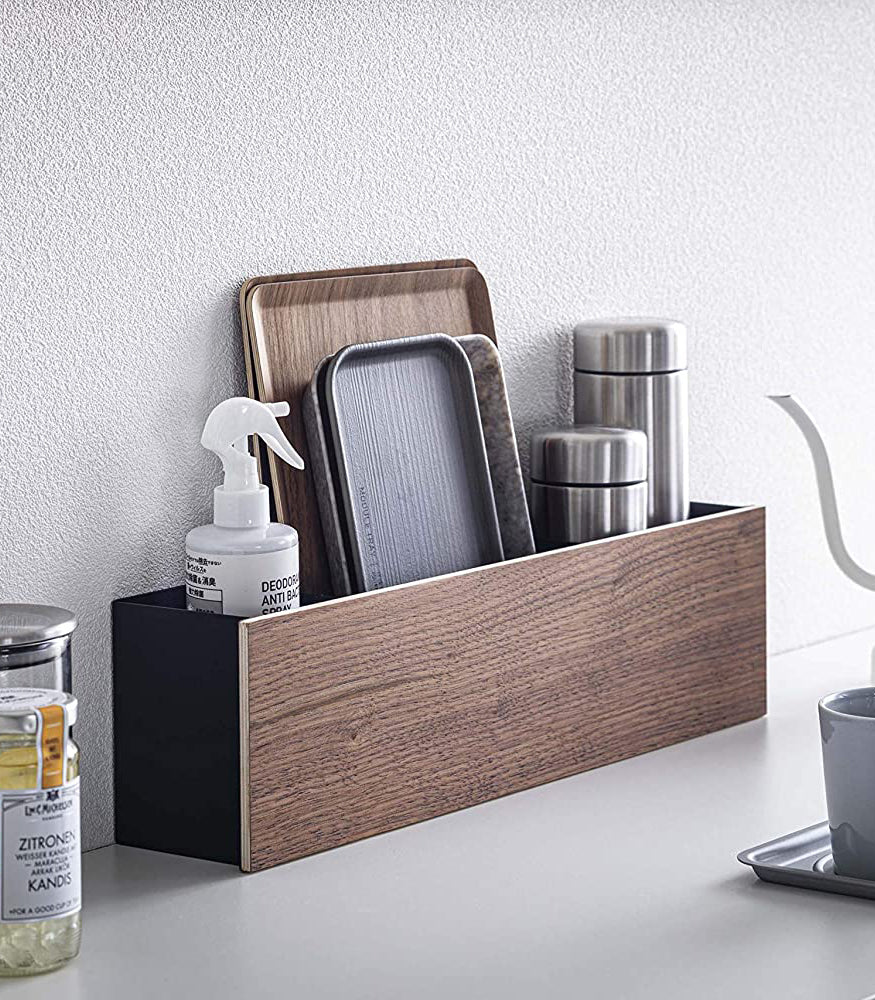 View 20 - Black Desk Organizer holding cleaning items, trays, and containers by Yamazaki Home.