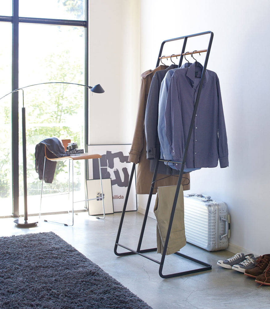 View 8 - Black 2-level Coat Rack displaying clothes by Yamazaki Home.
