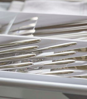 Close up view of white Cutlery Storage Organizer holding silverware by Yamazaki Home. view 3