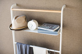Close up top view of white Leaning Ladder Rack with Shelf displaying hat, clock, and books by Yamazaki Home. view 13