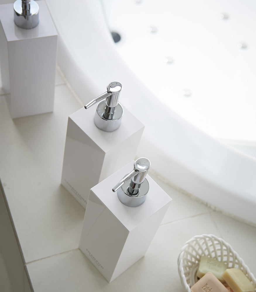 View 16 - Aerial view of square soap dispenser in three styles by bathtub