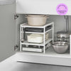 Yamazaki Home White Three-Tier Cabinet Storage Rack holding pot and pans under the sink with a 2026 Apartment Therapy Organization Awards logo on the top right.