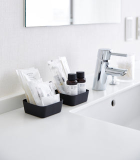 Small black Accessory Trays holding beauty items on bathroom sink counter by Yamazaki Home. view 5
