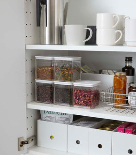 White Vacuum-Sealing Food Containers holding dry goods in kitchen cabinet by Yamazaki Home. view 6