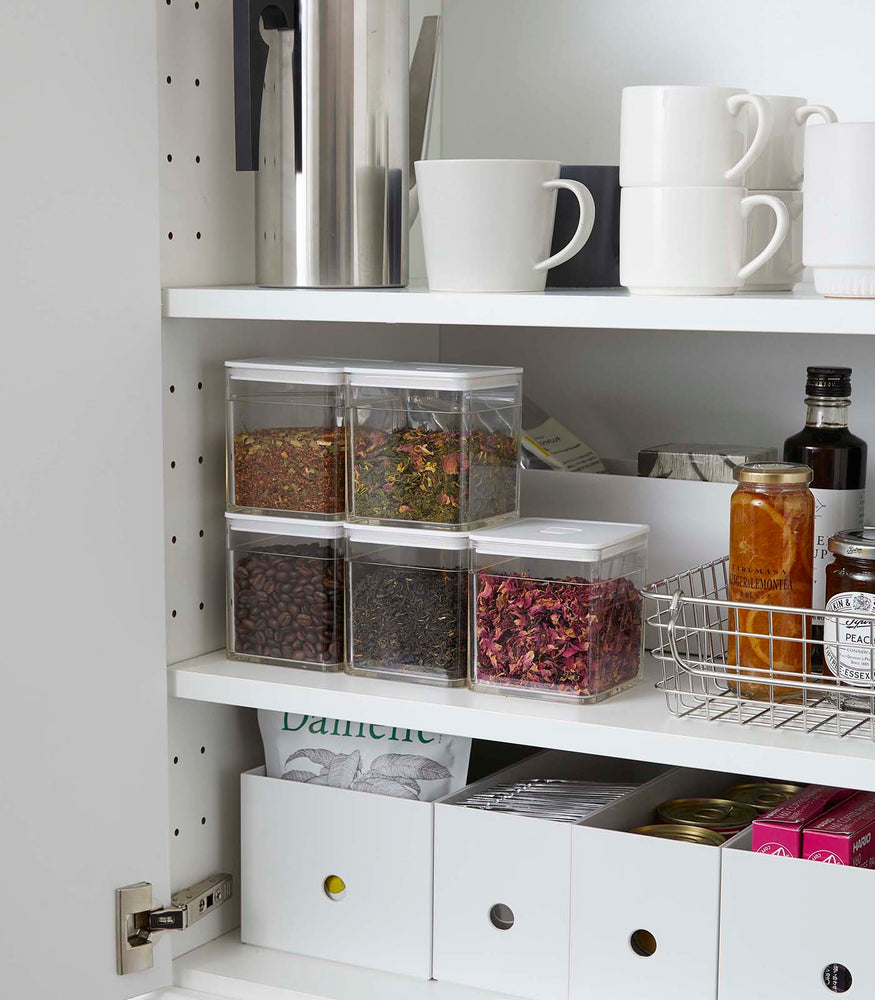 View 6 - White Vacuum-Sealing Food Containers holding dry goods in kitchen cabinet by Yamazaki Home.