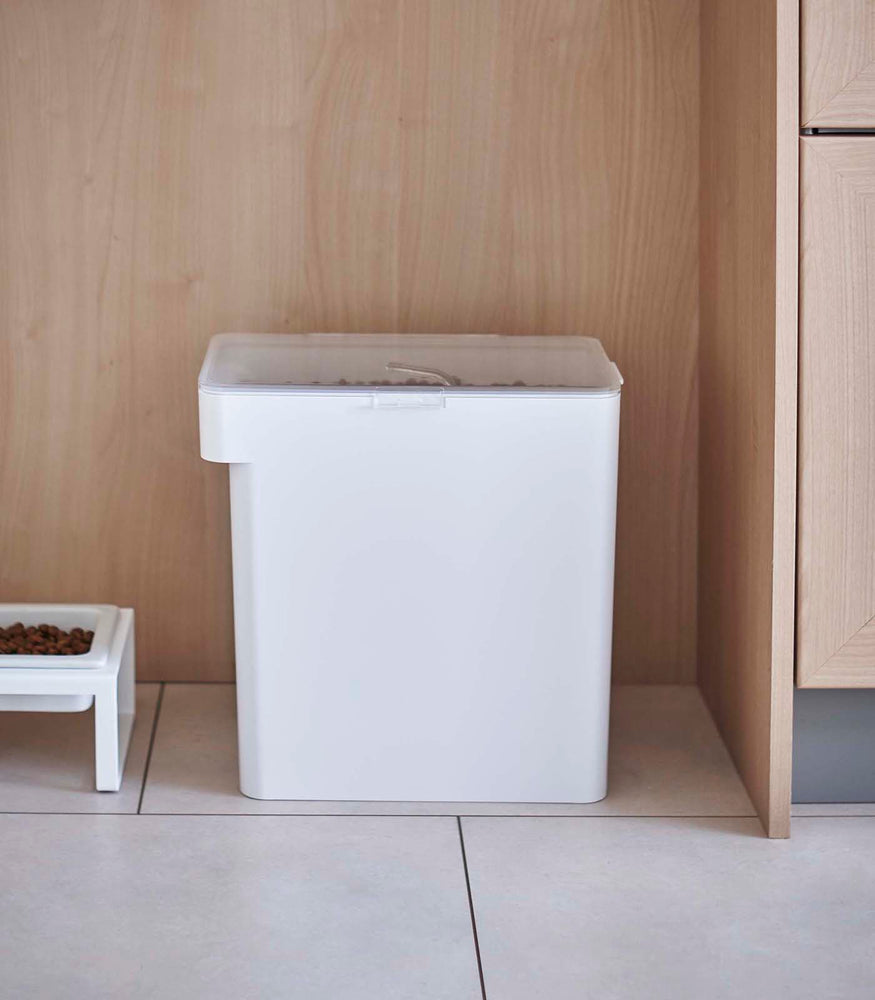View 43 - Front view of white Airtight Food Storage Container next to white Pet Food Bowl by Yamazaki Home.