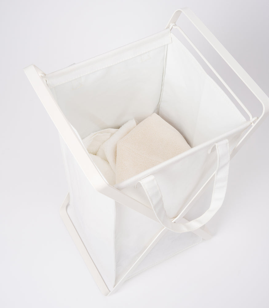 View 3 - Small Laundry Hamper with Cotton Liner by Yamazaki Home in white on a white background with white towels inside.