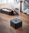 Black Vacuum-Sealing Bento Box on table by Yamazaki Home.